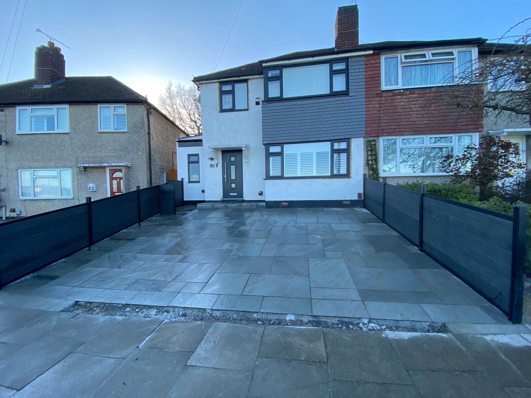 new grey block paving driveway infront of semi-detatched white home